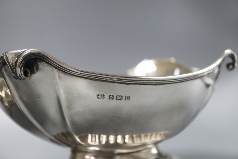 A pair of George V oval silver bowls with scrolling rims and heavy fluted bases, stamped Alexander Clark Co London, but hallmarked for